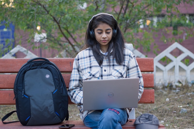 Young student learning online with laptop and headphones